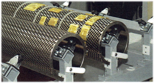 Die types: curved brass foiling die segments mounted on a rotary honeycomb base. Segmented dies allow mounting individual brass pieces instead of a single continuous shell to reduce cost and increase flexibility.