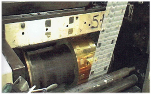 Die types: brass sleeve die. An imaged brass sleeve is mounted over a heated base cylinder. The sleeve reduces die mass by covering only the image width and allows precise lateral and circumferential positioning.