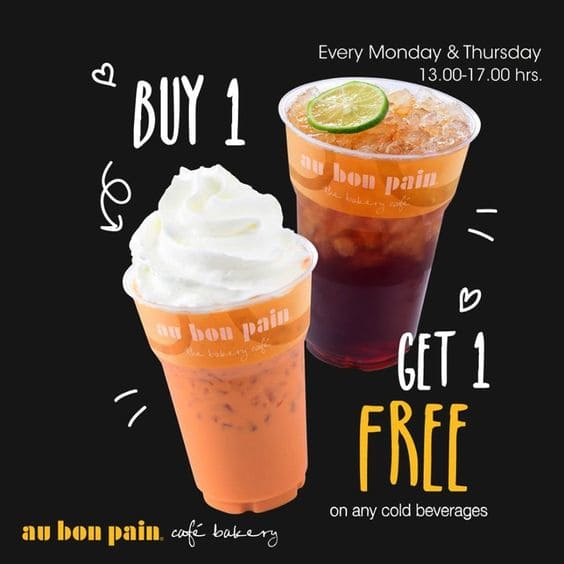 Drink promo sign: Buy 1 Get 1. Black background with white/yellow text, real product photo, dates shown — a clear, sales-driven design.