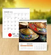 Square Desk Calendar, size 5.5” × 5.5”.  Inside pages: Art card 230 gsm, offset printing, 4-color, double-sided.  Total 14 sheets: 1 cover page, 12 monthly calendar pages, plus 1 yearly overview page for the following year.  Stand: Chipboard wrapped with 100 gsm white bond paper.  Binding: Twin-loop wire binding with 4 rings, 2 positions punched.